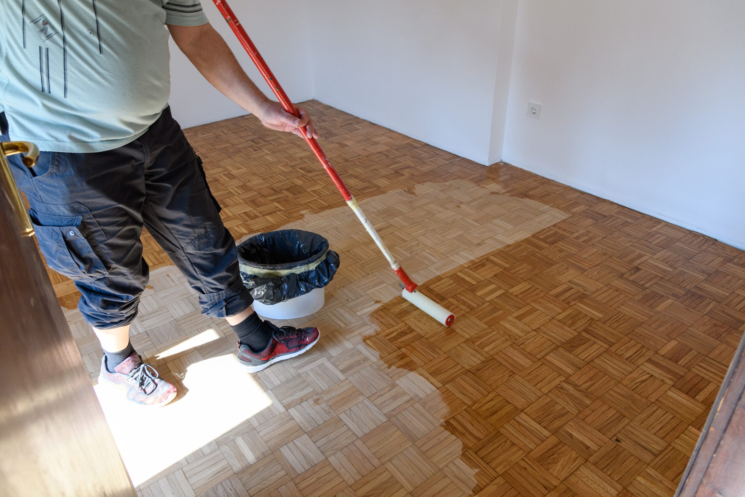 man-applying-lacquer-finish-on-oak-hardwood-floor-2023-11-27-05-00-29-utc (1)